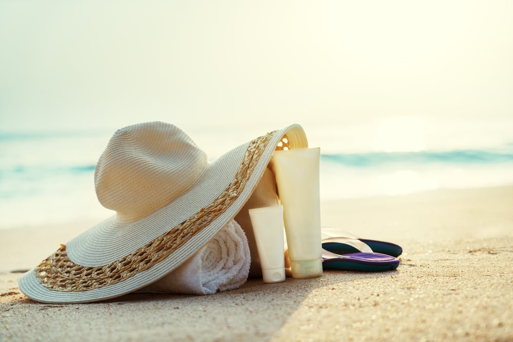 Sun lotion, hat  with bag at the tropical beach-1